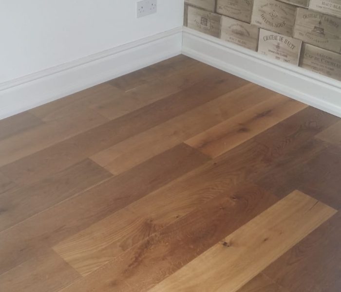 V4 Oak Smoked VIT108 transforms this home by changing a traditional herringbone into a modern and stylish straight plank hardwood.